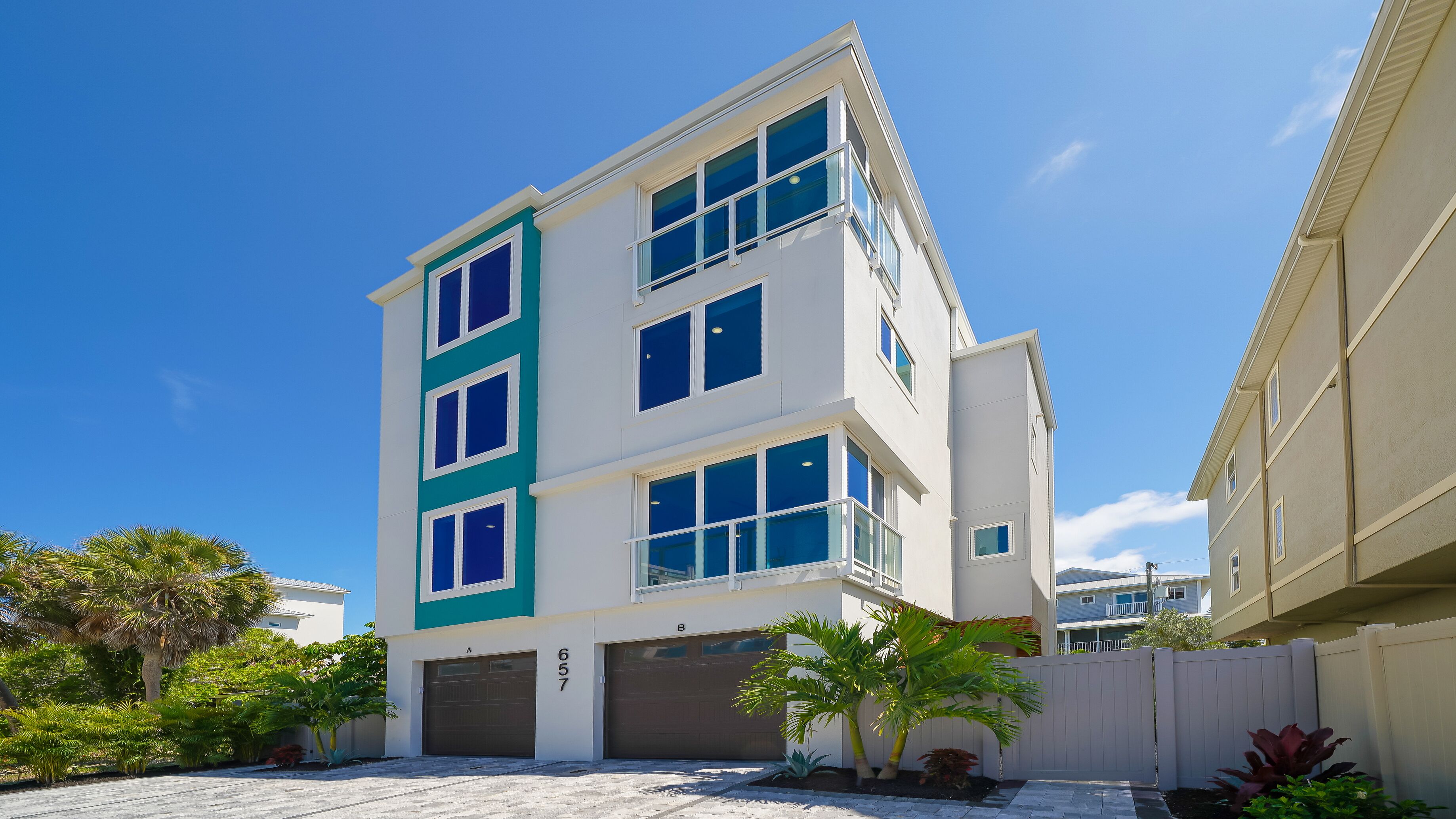 A multi-story residential building with a garage, numbered 657, and a balcony.