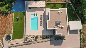 An aerial view of a modern building with a swimming pool, outdoor seating, and landscaped areas. - Cozy home in Grubine with sauna (Grubine)