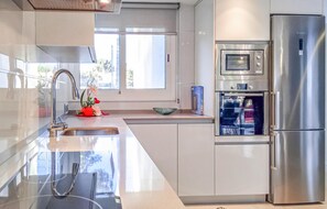 Fridge, stovetop, dishwasher, coffee/tea maker