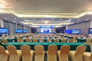 A conference room with rows of tables and chairs, equipped with water bottles and nameplates. - Yujinzhou Hotel (Chongqing)