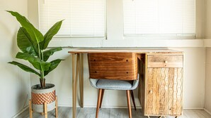 A wooden desk with a drawer, a chair, and a potted plant. - La Casita of St. Petersburg near Beaches and Bars! (St. Petersburg)
