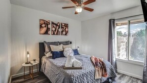 A bedroom with a bed, a ceiling fan, a window, and artwork on the wall. - ☺ Just Remodeled ☺ 3 Bed / 2 Bath Sparkling Townhouse with Patio! ☺ (Mesa)