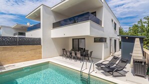 A modern two-story house with a swimming pool, outdoor seating, and a covered patio area. - Modern holiday house JASMINKA (Malinska)