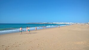 A wide sandy beach with footprints leading to the water. - Villa Maren, quiet residential area, private pool (Lagos)