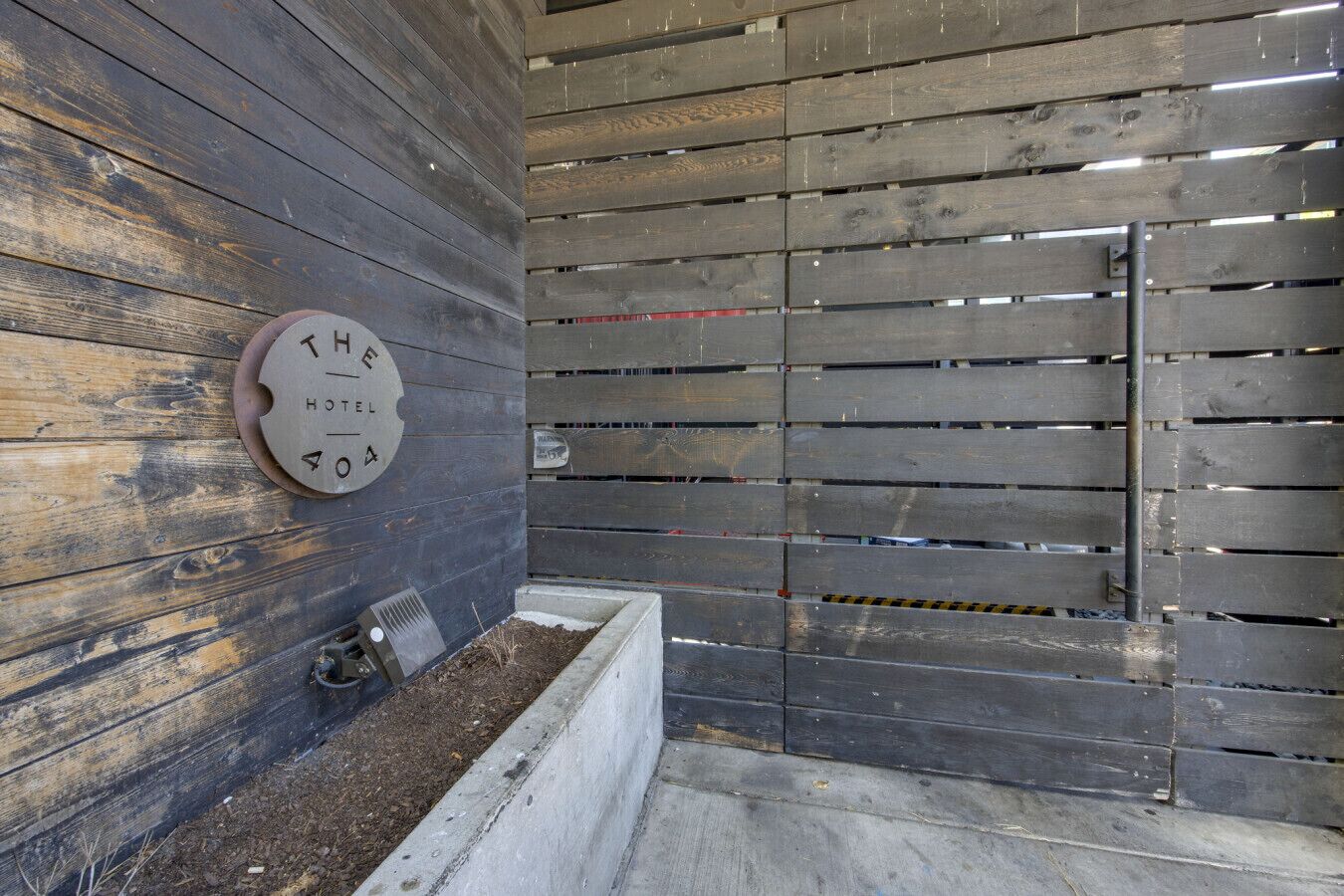 Una pared de madera rústica con una placa que dice 'THE HOTEL HOTEL HOTEL HOTEL'.