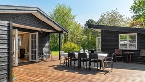 A wooden deck with outdoor seating and a fireplace. - 4 bedroom lovely home in Vejby (Vejby)
