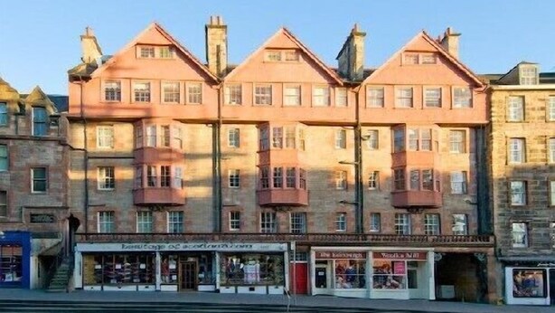 A row of terraced houses with a ground-floor shop.