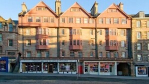 A row of terraced houses with a shop at the ground level.