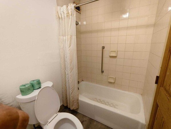 A bathroom with a toilet, a shower with a curtain, and a bathtub. - Plaza Hotel By OYO Calumet Park Near Alsip I 57 (Calumet Park)