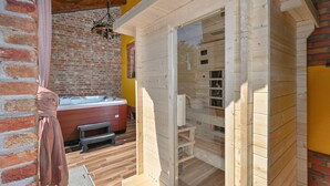 A wooden sauna with a glass door, a hot tub, and a brick wall. - Cozy home in Gornja Ploscica (Gornja Ploscica)