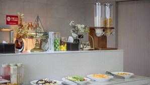 A buffet setup with various food items and condiments. - Hangzhou Dingqiao Kaiyuan Yiju Hotel (Hangzhou)