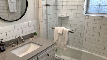Bathtub, hair dryer, towels, soap