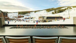 A ski resort with a chairlift, a ski slope, and a building in the background. - SPRING BREAK - SLOPESIDE Luxury Ski-in/Ski-out- Grand Colorado Peak 8 - SLEEPS 4 (Breckenridge)
