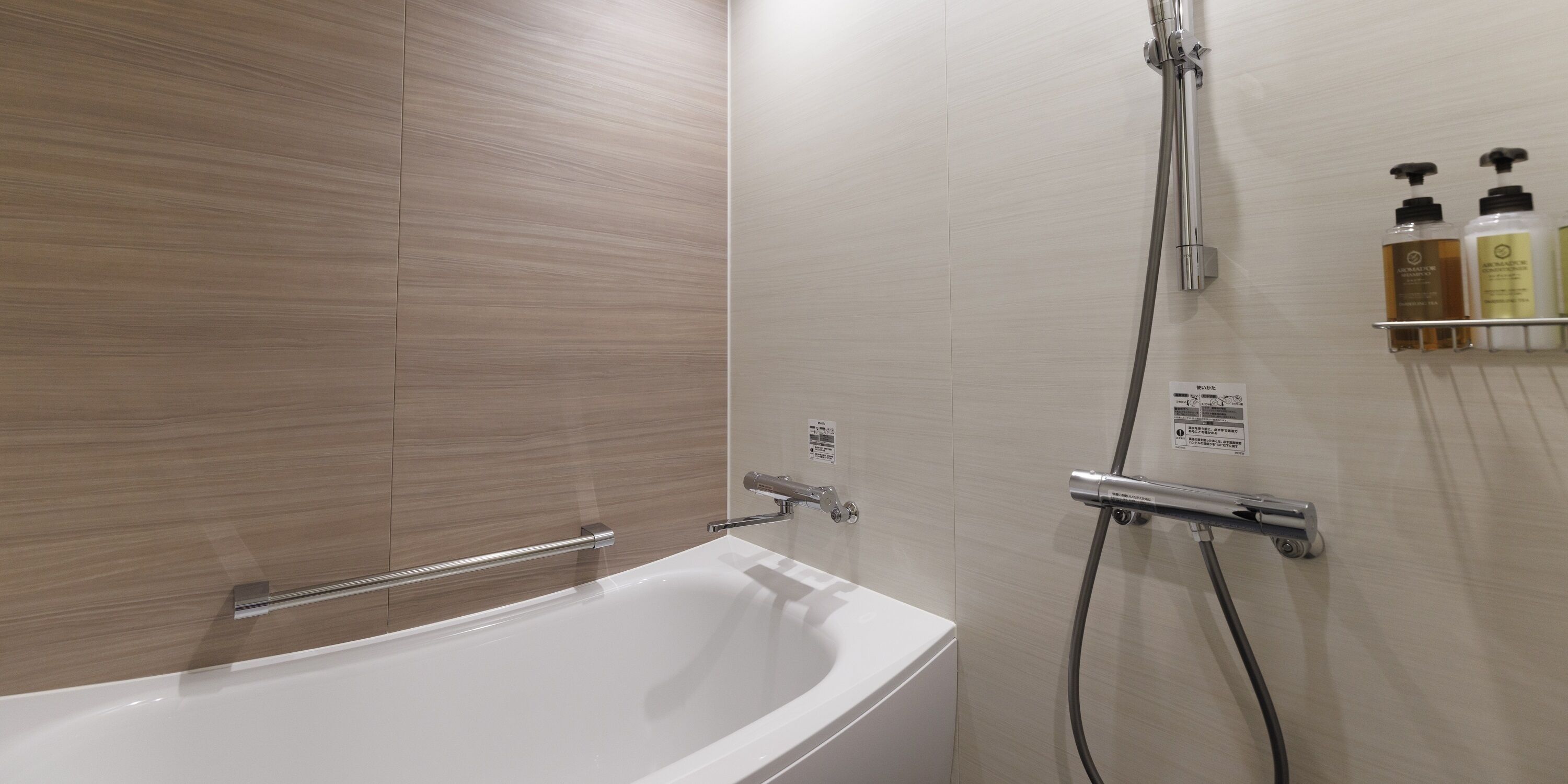 Un baño moderno con bañera, ducha y un estante con artículos de aseo.