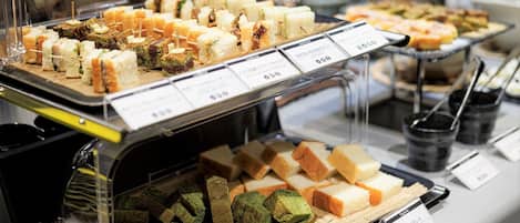 A buffet with various food items and price tags.