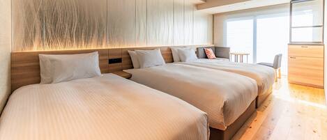 A modern hotel room with two beds, a wooden headboard, a large window, and a balcony.