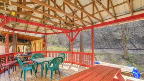 A covered outdoor area with wooden benches, tables, and chairs. - Direct Warrior Trail Access! Ultimate ATV Getaway (Gary)