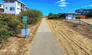 A pathway leading to a beach with a sign indicating '96 A Ocean Blvd Beach Access'. - 🦀 Knot Too Crabby - 5 BR home w/Private Pool & Hot Tub 🦀 (Southern Shores)
