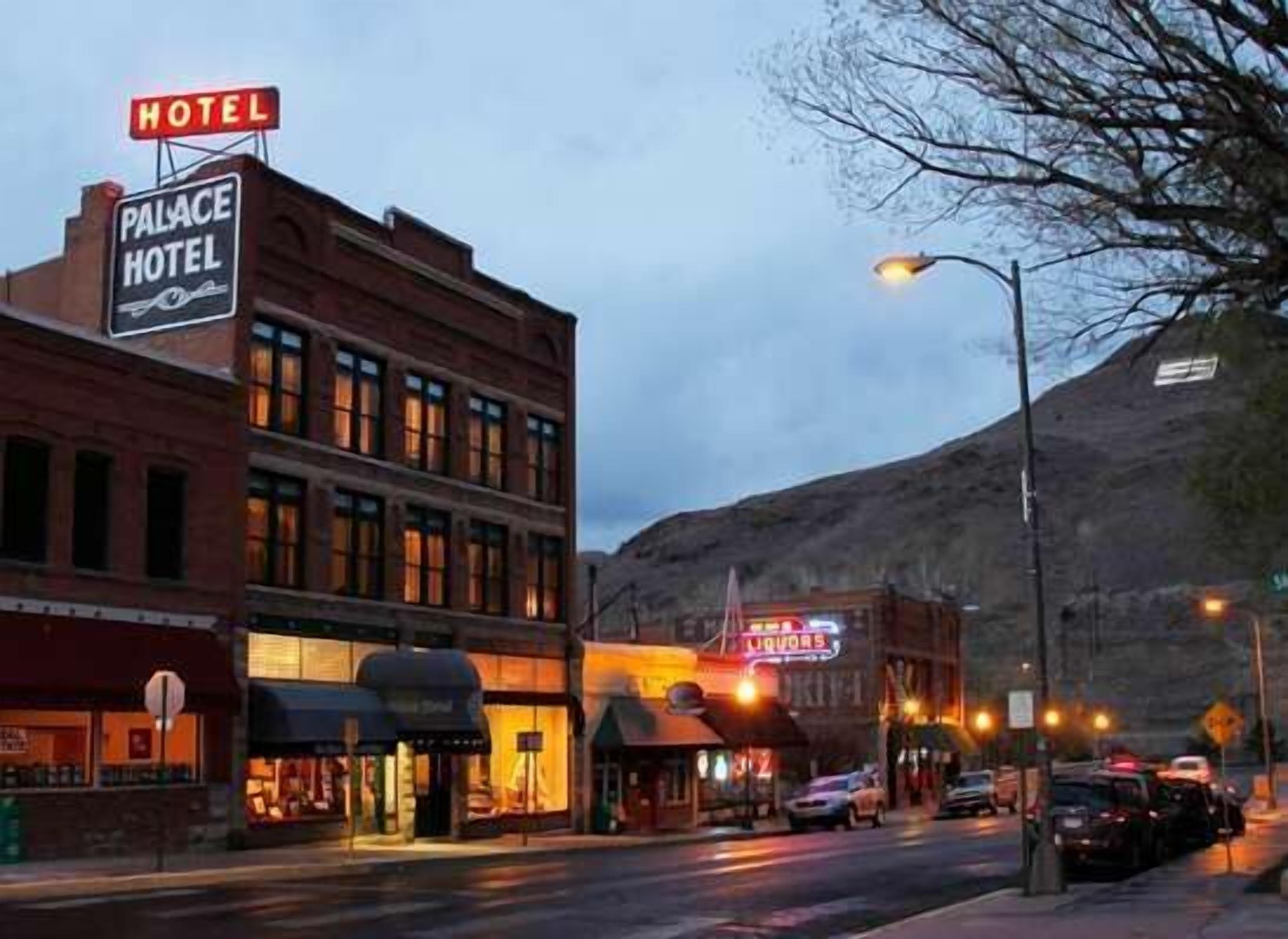 A hotel with a sign reading "Palace Hotel" and "Hotel" above it.