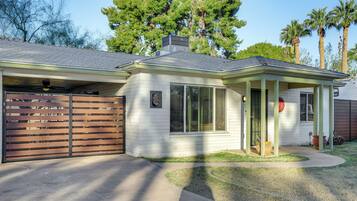 A single-story house with a covered porch, a garage, and a small front yard.