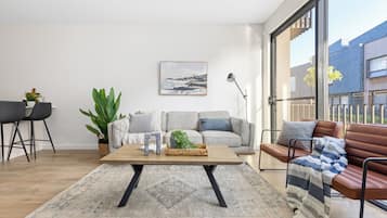 Three Bedroom Townhouse With Parking | Living area | Flat-screen TV