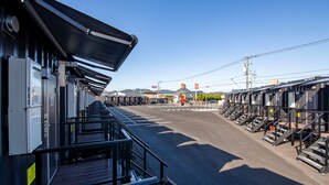 A train station platform with multiple tracks and a clear sky.