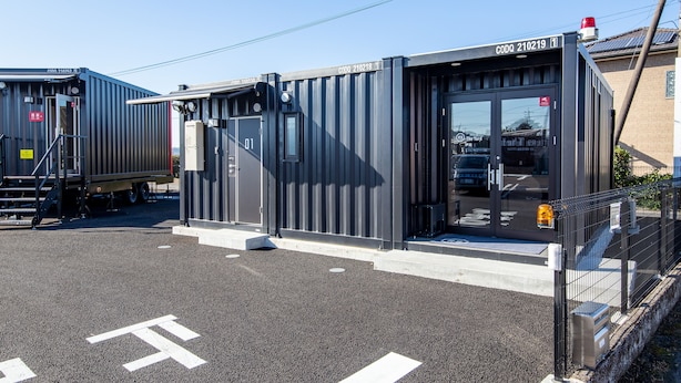 A modern industrial building with a metal exterior, a loading dock, and a clear sky. - HOTEL R9 The Yard Isa (Isa)