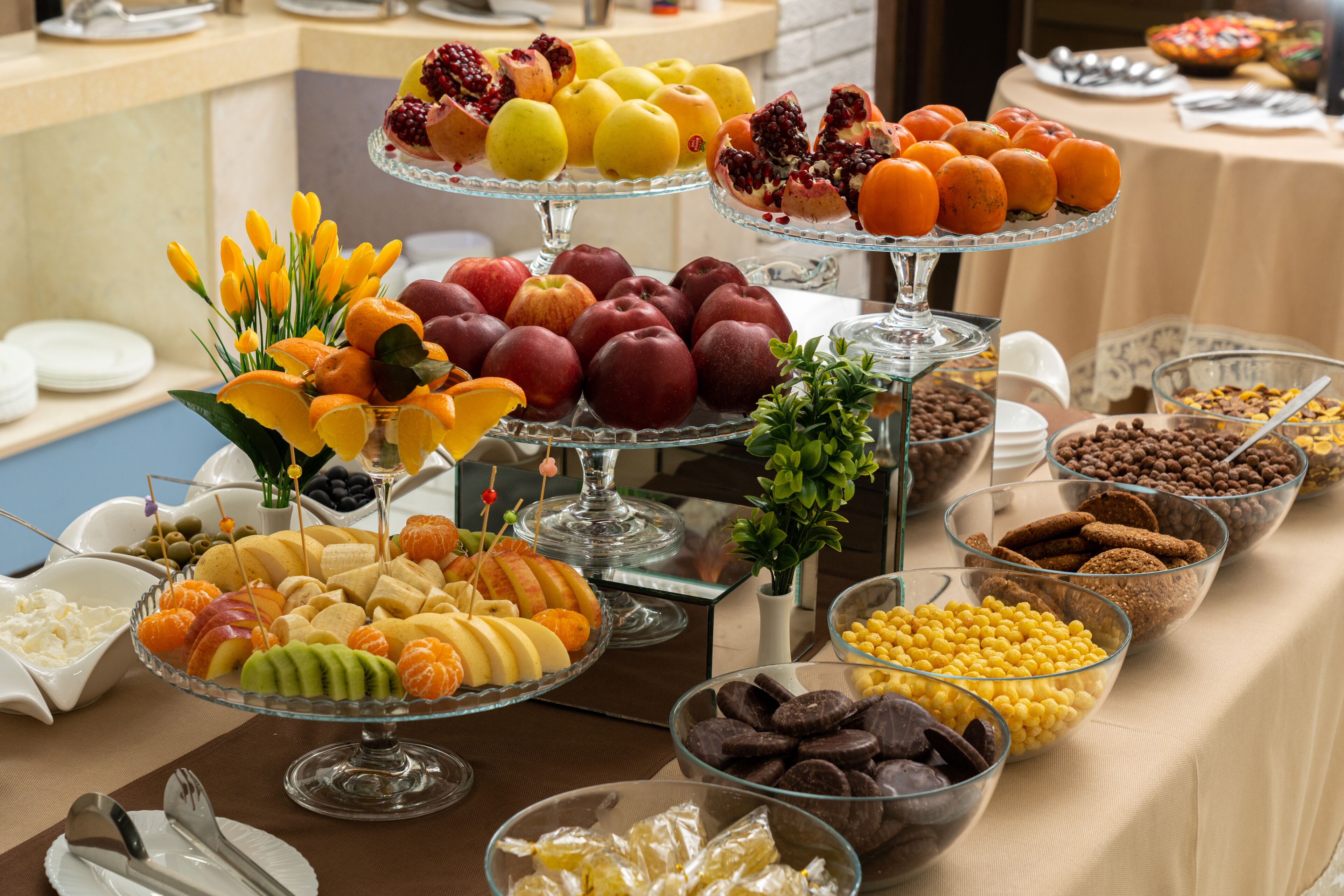 A buffet with various food items including fruits, vegetables, and desserts.