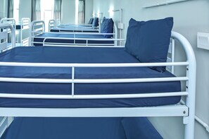 A row of bunk beds with white railings and dark blue bedding. - Spot ON 90449 Bed Station Guest House Dormitory (Tanah Rata)
