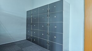 A row of lockers with numbers 1 to 18. - Spot ON 90449 Bed Station Guest House Dormitory (Tanah Rata)