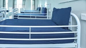 A row of bunk beds with white railings and dark blue bedding. - Spot ON 90449 Bed Station Guest House Dormitory (Tanah Rata)