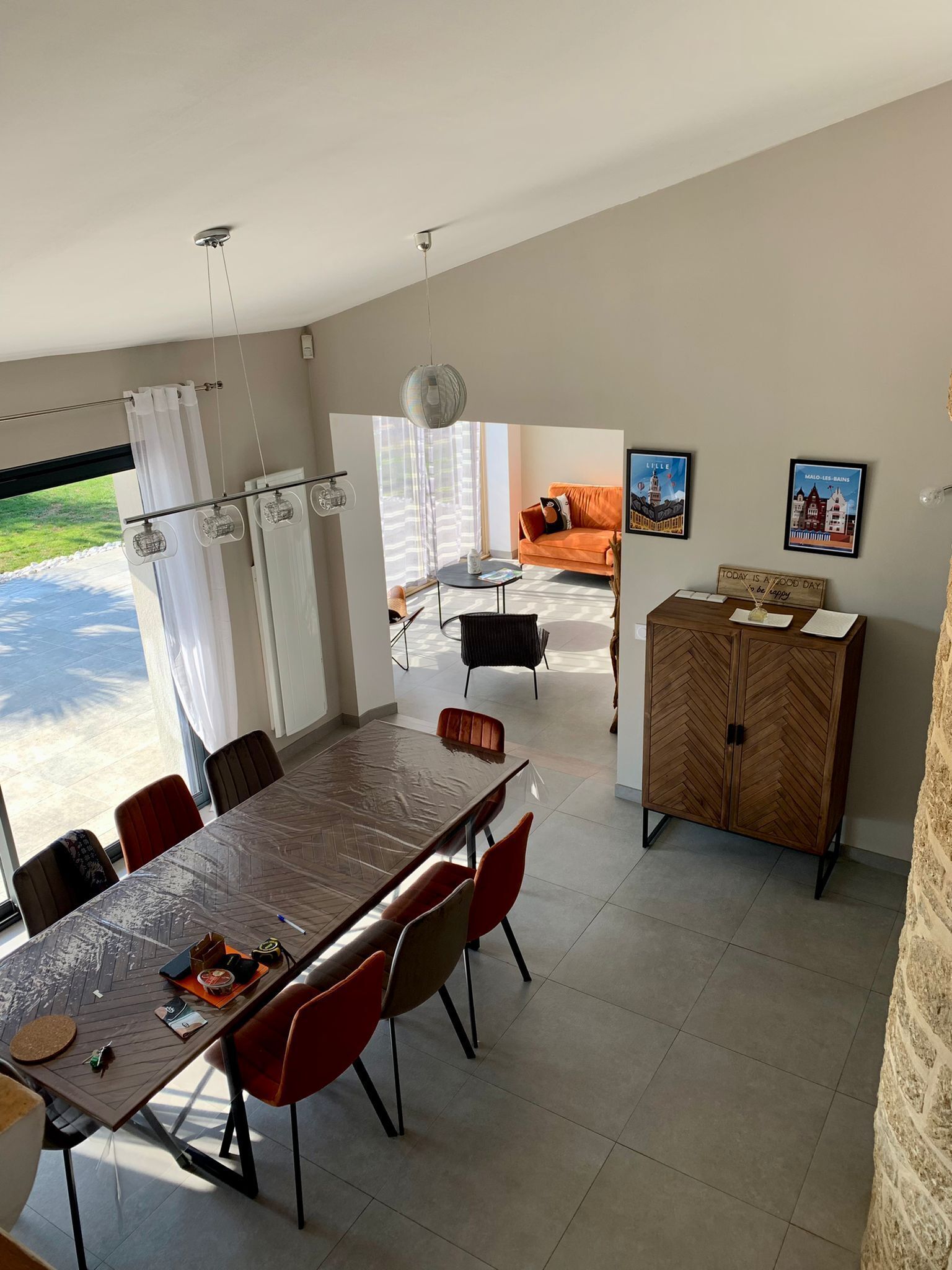 A dining area with a large table, chairs, and a cabinet.