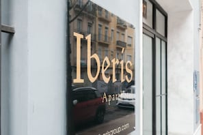 A window with the text "Iberis Aparthotel" and a reflection of a car. - ≼ Clean & Cozy Room close to City Centre ≽ (Valencia)