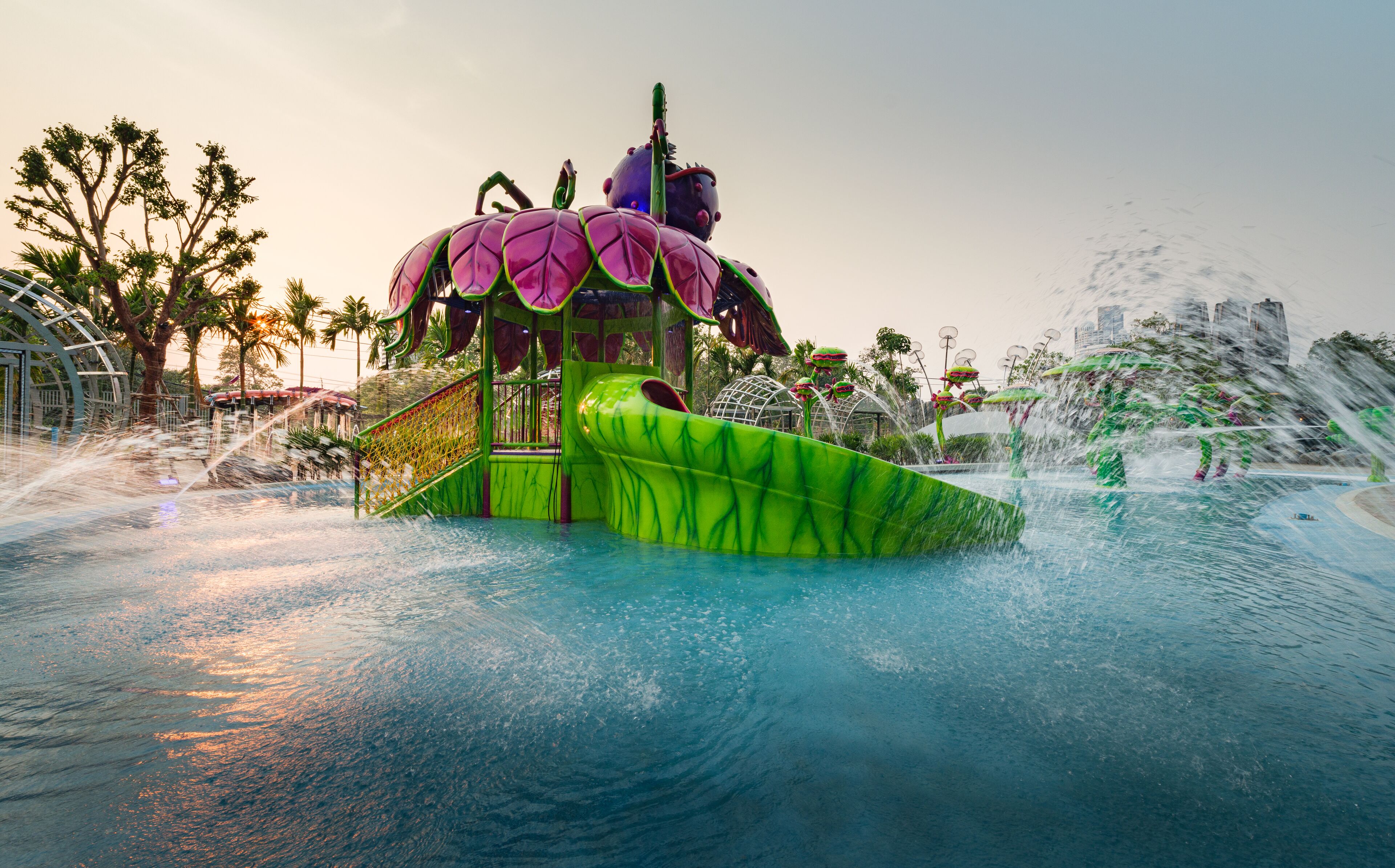 A water park with a large, colorful water slide and a green and purple structure.