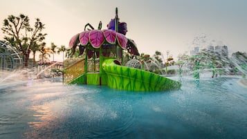 A water park with a large, colorful water slide and a green and purple structure.