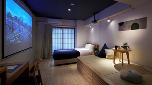 A modern hotel room with a bed, a desk, a projector screen displaying a cityscape, and a small table with a plant. - Minn Shin-Osaka (Osaka)