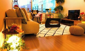 Relax in this inviting living space with a comfortable sofa, accent chair, and city views.