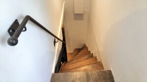 A staircase with wooden steps and a metal handrail. - Medieval Getaway (Fougères)