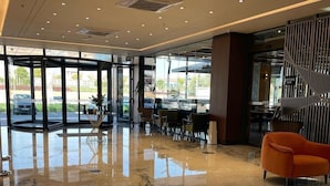 A spacious lobby with a marble floor, modern furniture, and large windows offering views of the parking area. - Spark Hotel Residence Konya (Konya)