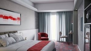 A modern hotel room with a bed, a red armchair, a desk, and a large window with curtains. - Spark Hotel Residence Konya (Konya)
