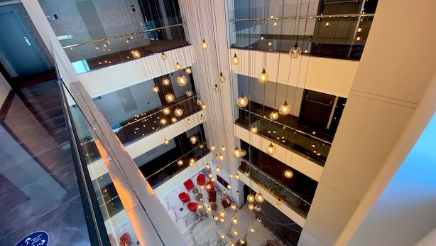 A multi-level atrium with modern furnishings, glass railings, and hanging pendant lights. - Spark Hotel Residence Konya (Konya)