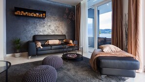 A modern living room with a sofa, ottomans, a coffee table, and a view of the outdoors. - Luxury  Villa   Adrian (Vela Luka)