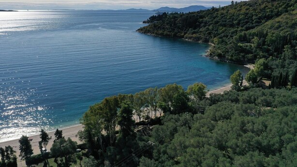 A coastal landscape with a clear view of the sea, a beach, and dense greenery. - Kerasia Bay View Villa (Corfu)