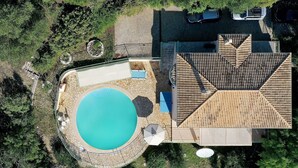 An aerial view of a property with a swimming pool, a covered patio, and a multi-level roof structure. - Kerasia Bay View Villa (Corfu)