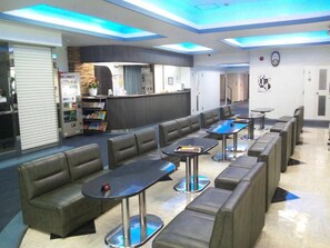Relax and socialize in our lounge area, featuring cushioned benches and individual tables.