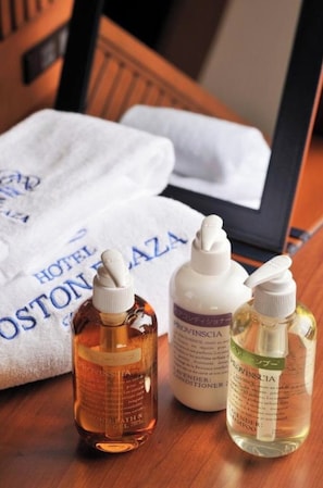 Three bottles of toiletries on a wooden table with a white cloth that reads "HOTEL OSTONZA". - Standard Twin North Wing No Smoking Great Simp / Kusatsu Shiga (Kusatsu)