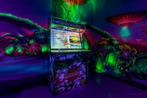 A neon-lit arcade with a selection of games, including '3D PANDORAS'.