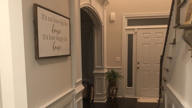 A hallway with a sign stating "It's not how big the house, it's how happy the home." - Beautiful  5 bdrm, 3 bthrm, 15 minutes to the Masters (Grovetown)