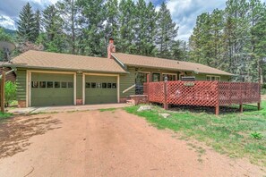 A single-story house with a garage, a covered porch, and a fenced outdoor area.