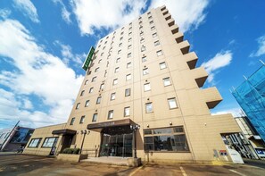Experience the hotel's sleek design, featuring spacious balconies and a sheltered entrance.